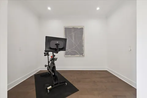 a view of a hallway with wooden floor and entryway