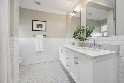 a spacious bedroom with a bed and a chandelier