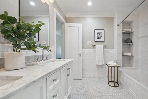 a bathroom with a double vanity sink a and a mirror