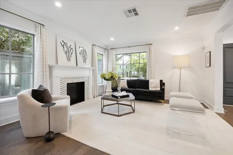 a living room with fireplace furniture and a large window