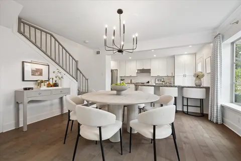a view of a dining room with furniture and chandelier