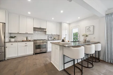 a view of a dining room with furniture and window