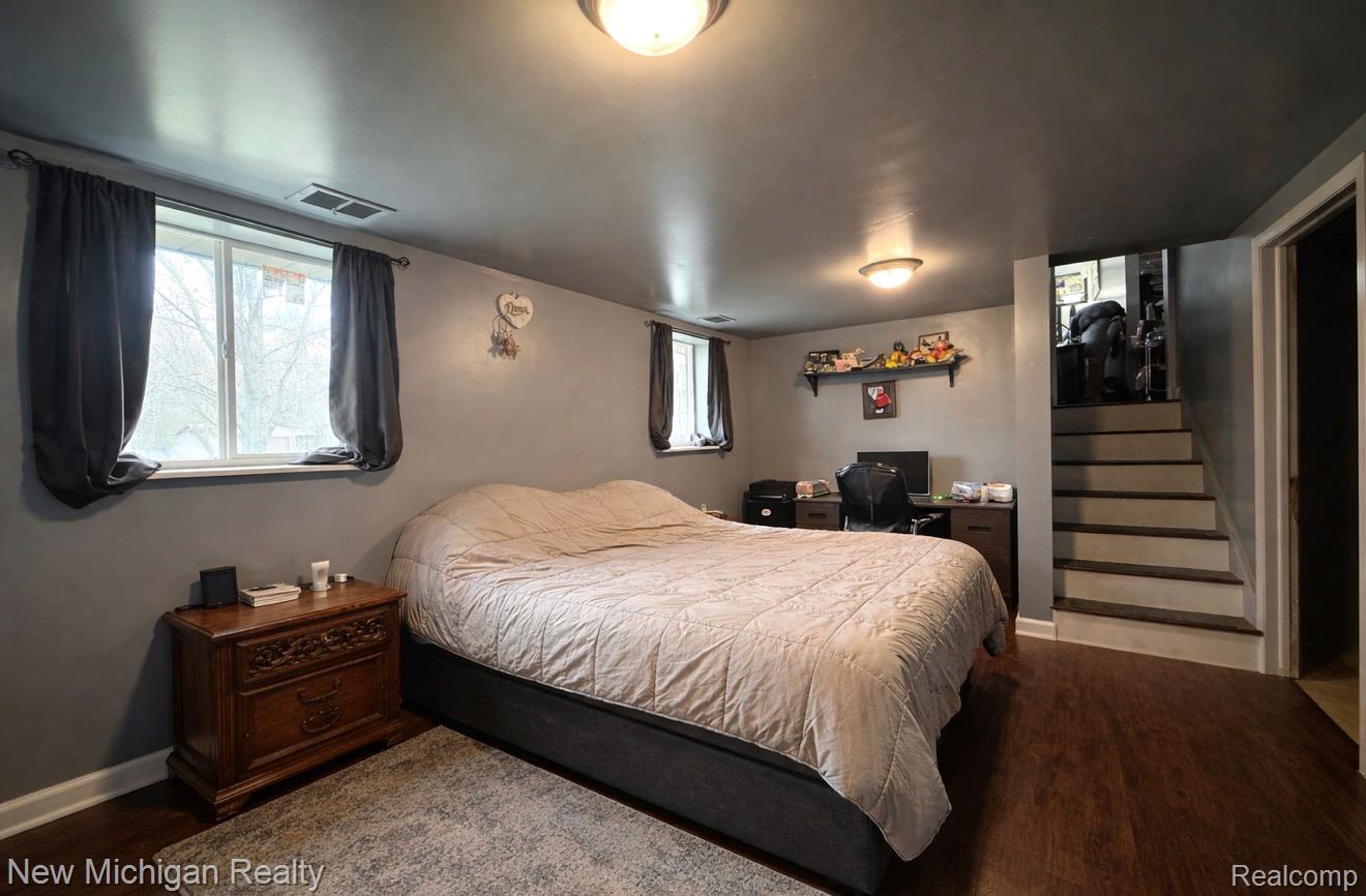 1054 Ransom Drive Flint, MI 48507 - Photo 21 of 27 Bedroom with dark wood finished floors and a desk