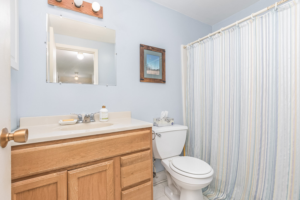 424 Devonshire Court Bolingbrook, IL 60440 - Photo 11 of 16 a bathroom with a toilet a sink and a mirror