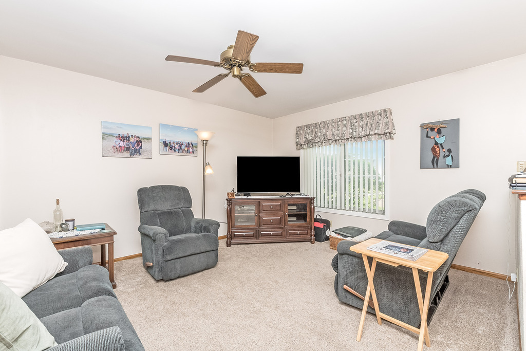 424 Devonshire Court Bolingbrook, IL 60440 - Photo 2 of 16 a living room with furniture and a flat screen tv