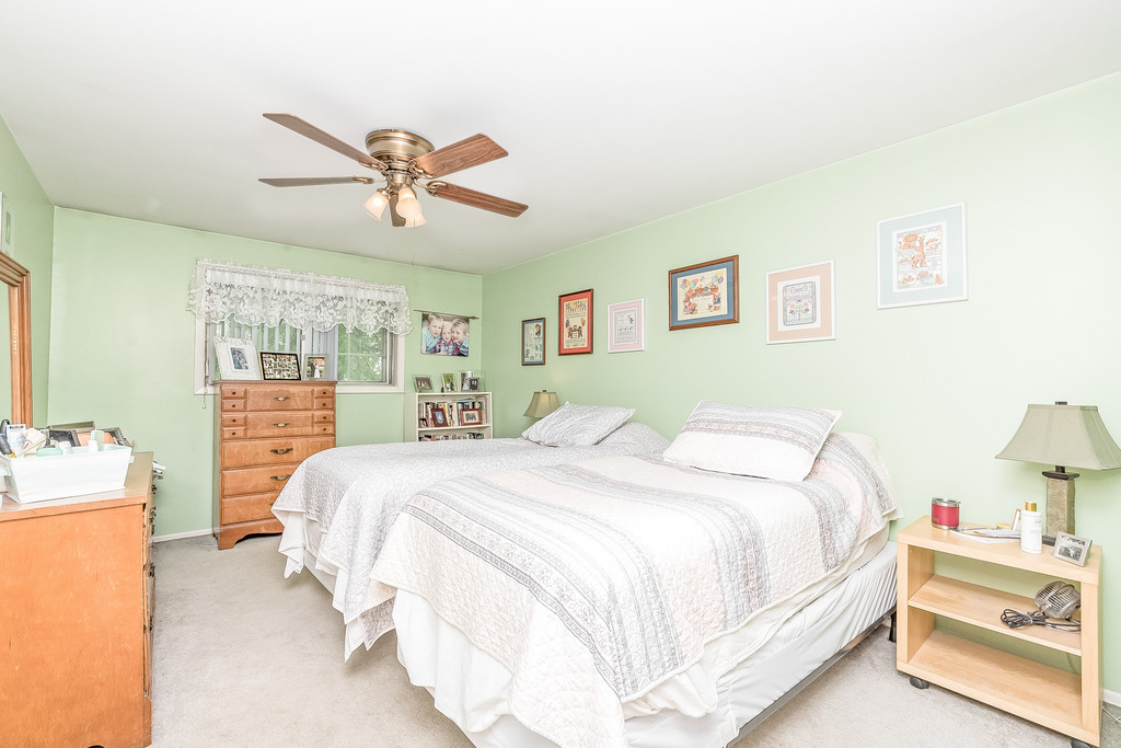 424 Devonshire Court Bolingbrook, IL 60440 - Photo 7 of 16 a bedroom with a bed and wooden floor