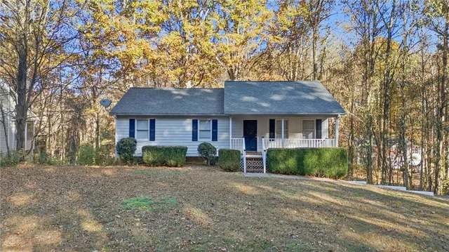 a front view of a house with a garden