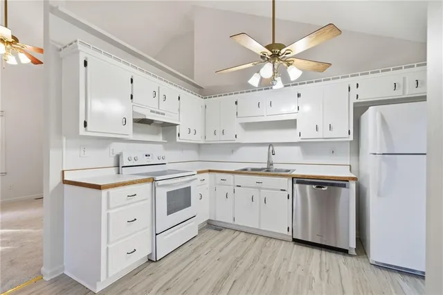 a kitchen with stainless steel appliances cabinets and a refrigerator