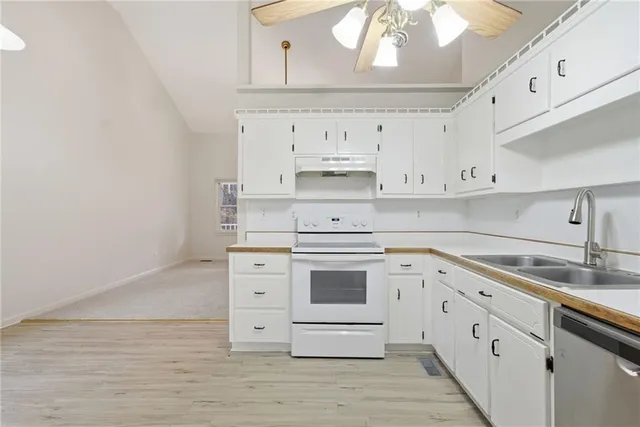 a kitchen with cabinets stainless steel appliances and a counter space