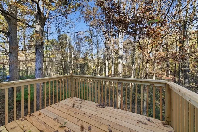a balcony with wooden floor and fence