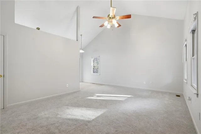 a view of a room with window and ceiling fan