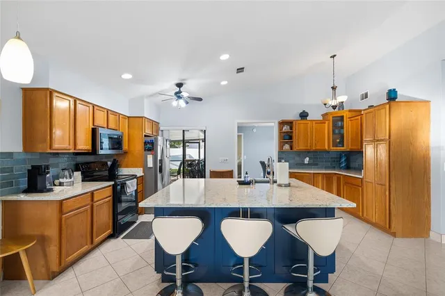 a kitchen with stainless steel appliances a stove refrigerator sink and cabinets