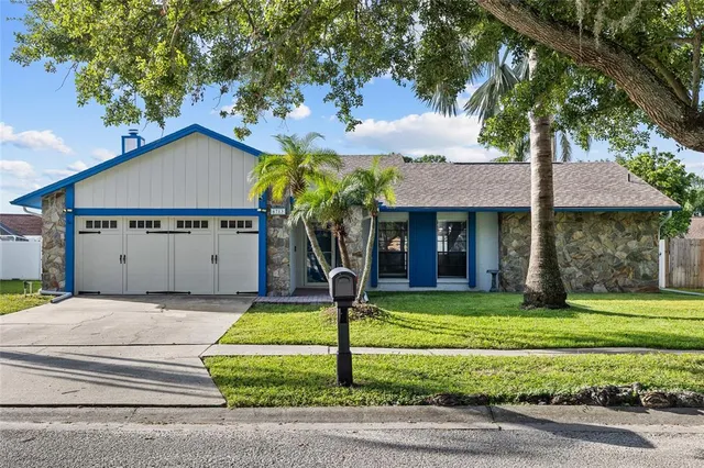 a front view of a house with a yard garage and outdoor seating
