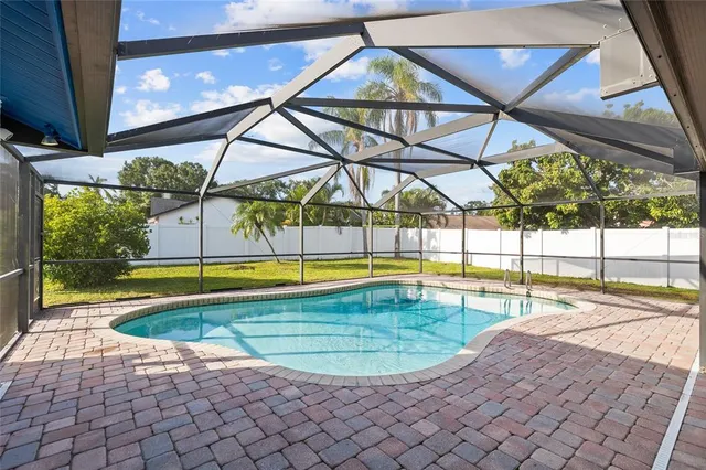 a view of a swimming pool with a lounge chairs