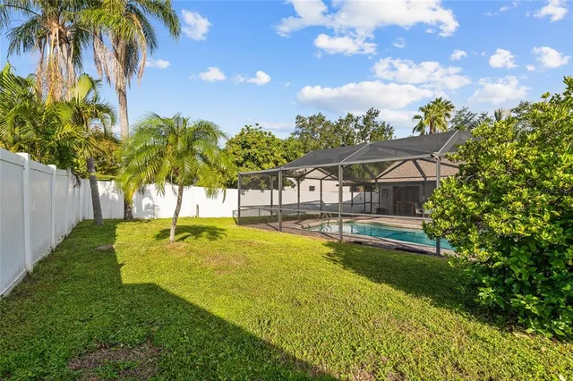 a swimming pool with some trees in the background