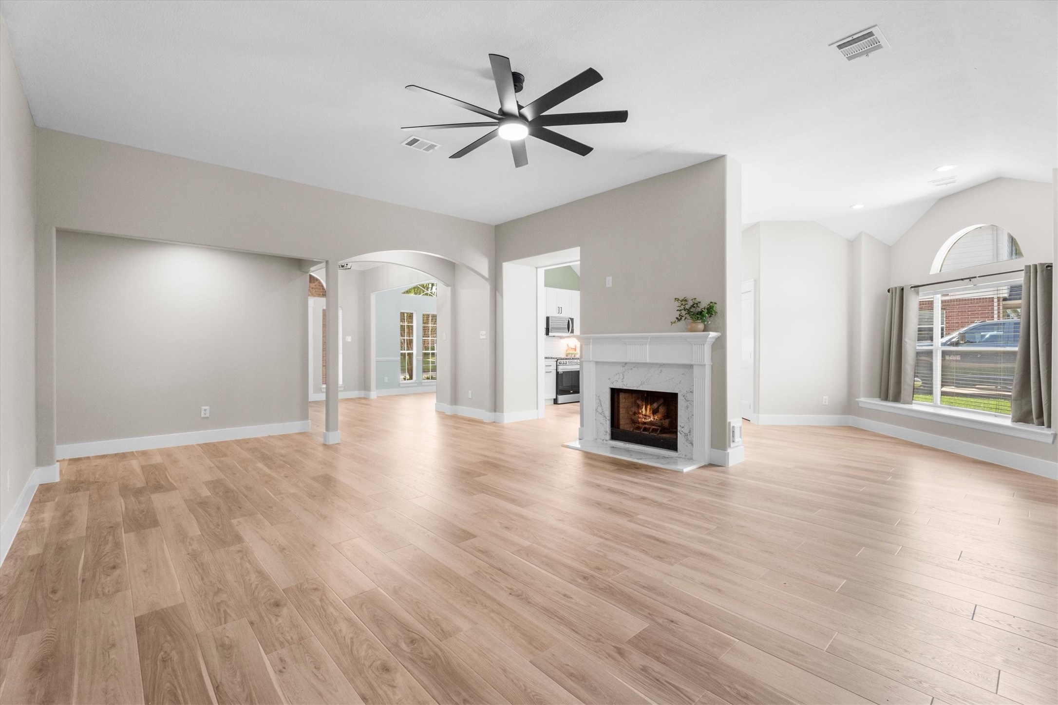30111 Granum Drive Spring, TX 77386 - Photo 28 of 45 a view of a livingroom with a fireplace a ceiling fan and wooden floor