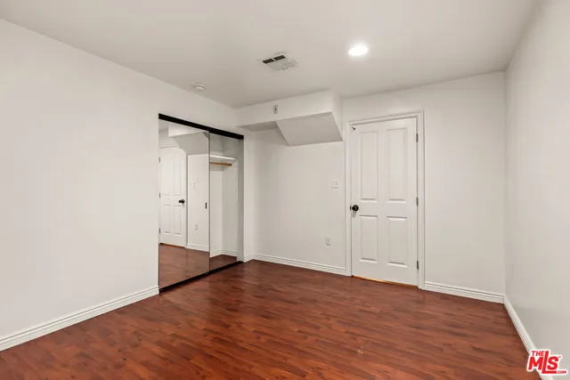 a bathroom with a granite countertop sink toilet a mirror a vanity and shower