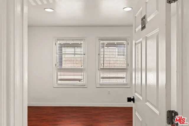 a bathroom with a granite countertop sink a mirror and a toilet