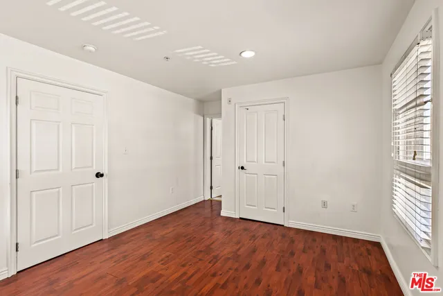a bathroom with a granite countertop sink vanity mirror and toilet
