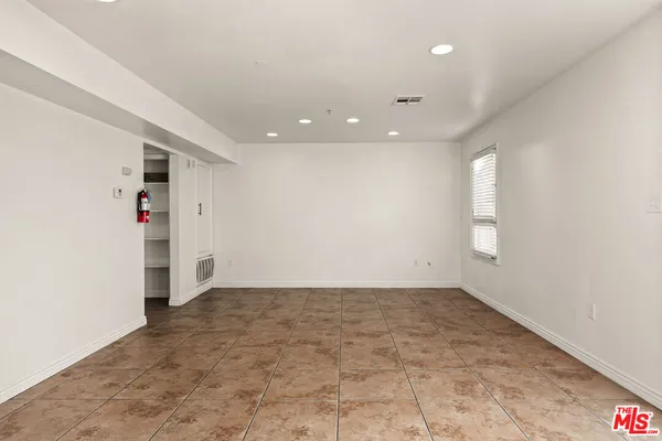 an empty room with staircase and white walls