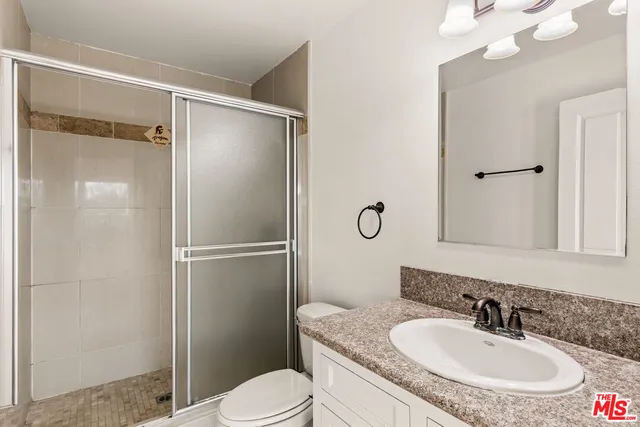 an empty room with wooden floor & closet area