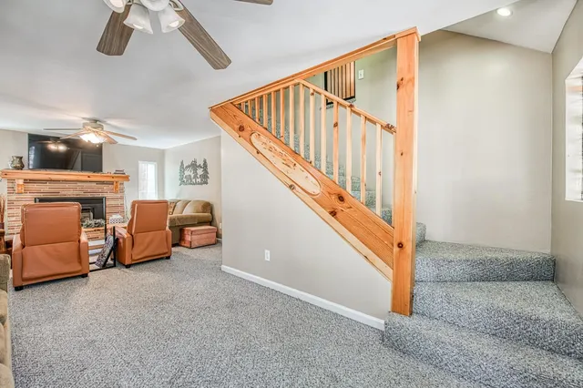 a view of a livingroom with furniture and staircase