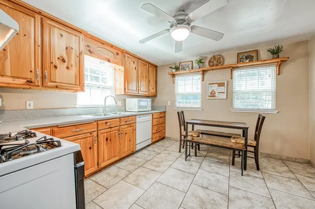 a kitchen with a stove a sink and a refrigerator
