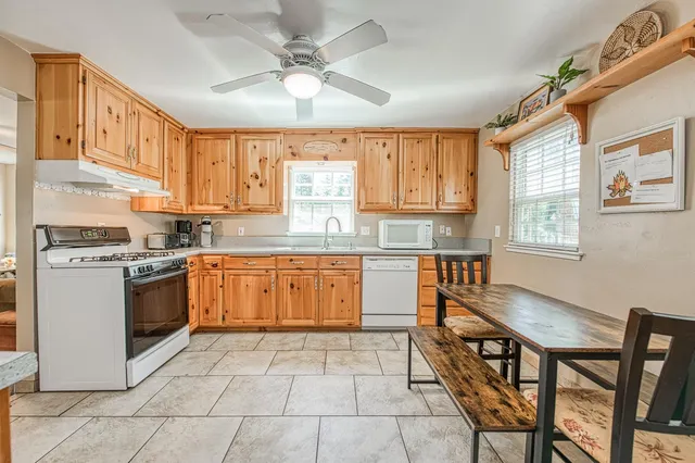 a kitchen with a stove a sink and a refrigerator