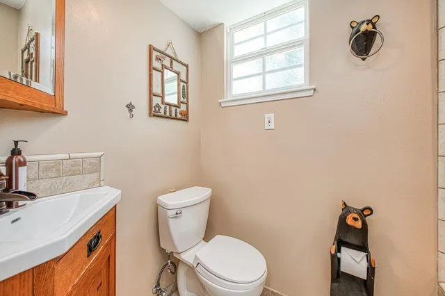 a white toilet sitting next to a bathroom sink