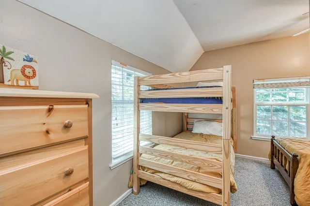 a bedroom with a bed and large window
