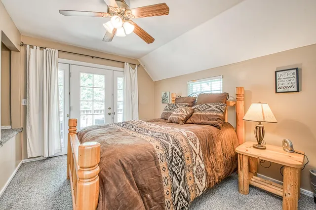 a bed room with a bed and a chandelier