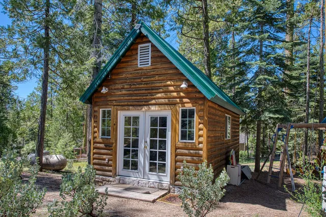a view of a house with a yard and potted plants