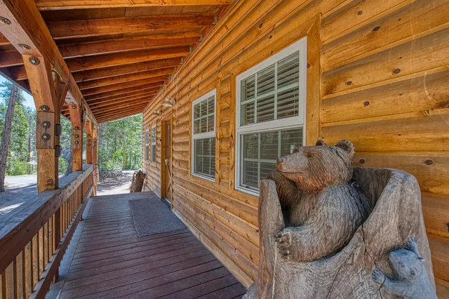 a view of a porch with wooden floor and iron stairs