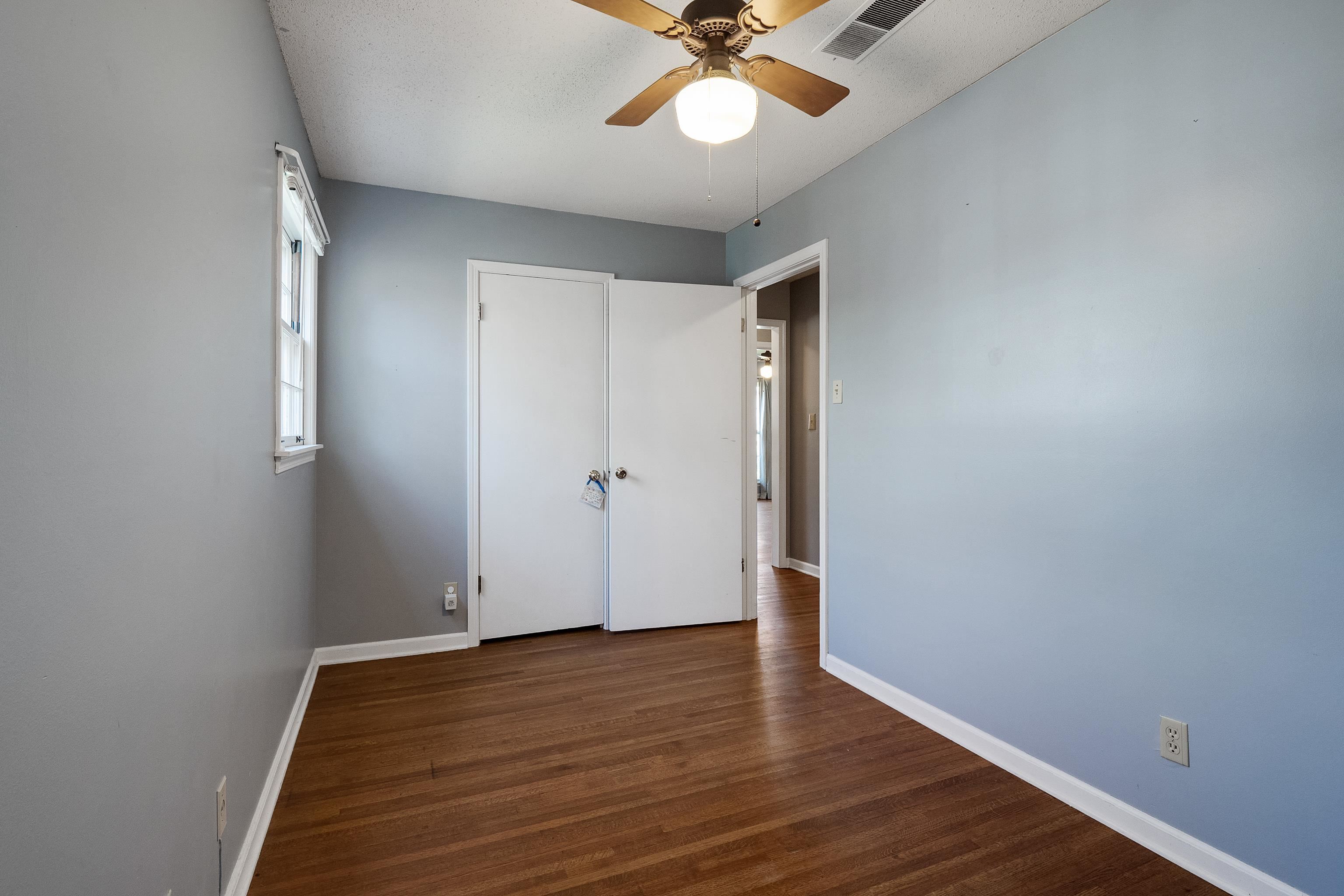 5849 Ridgevale Road Memphis, TN 38119 - Photo 16 of 22 a view of an empty room with wooden floor
