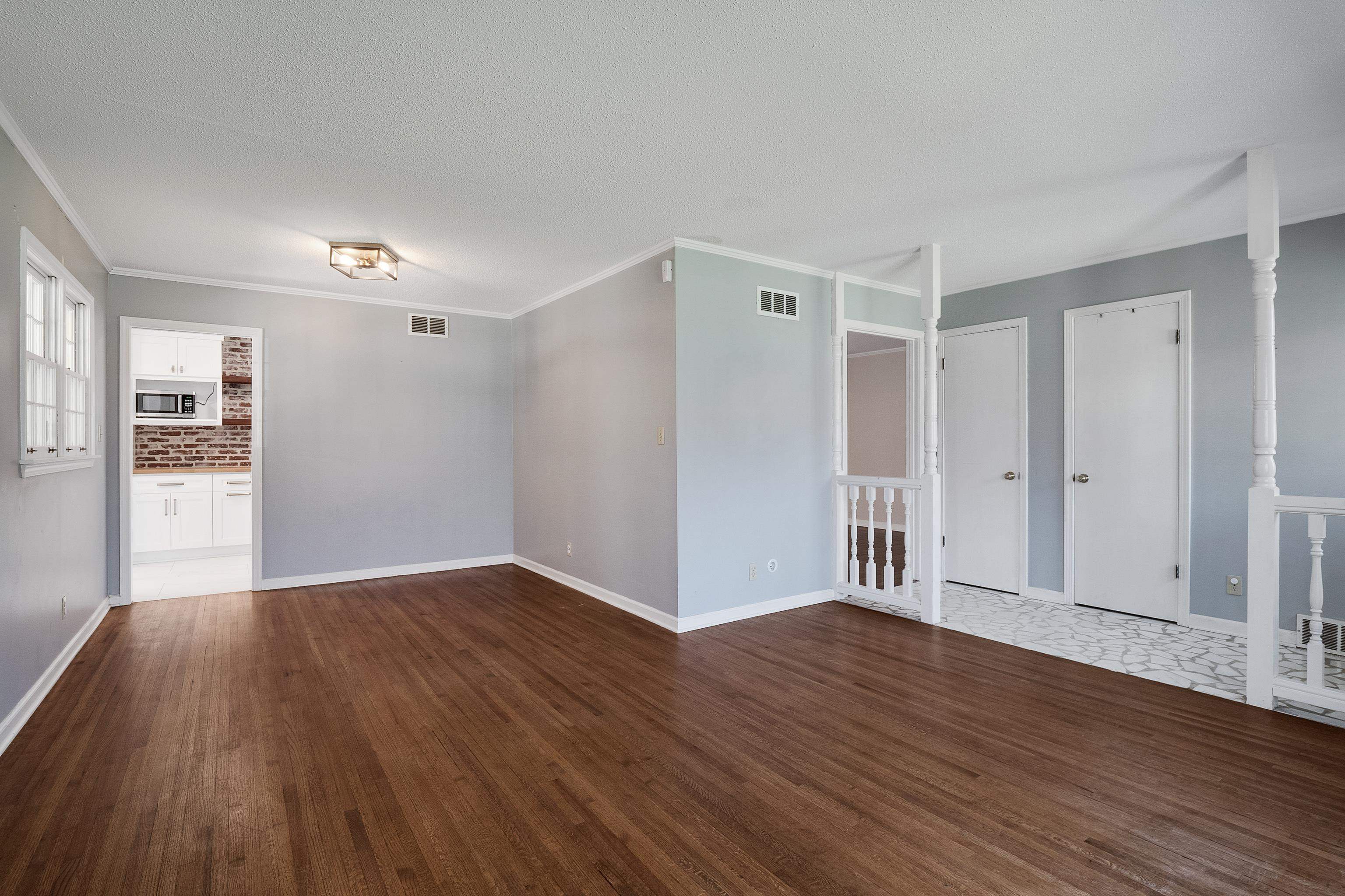 5849 Ridgevale Road Memphis, TN 38119 - Photo 4 of 22 a view of an empty room with wooden floor