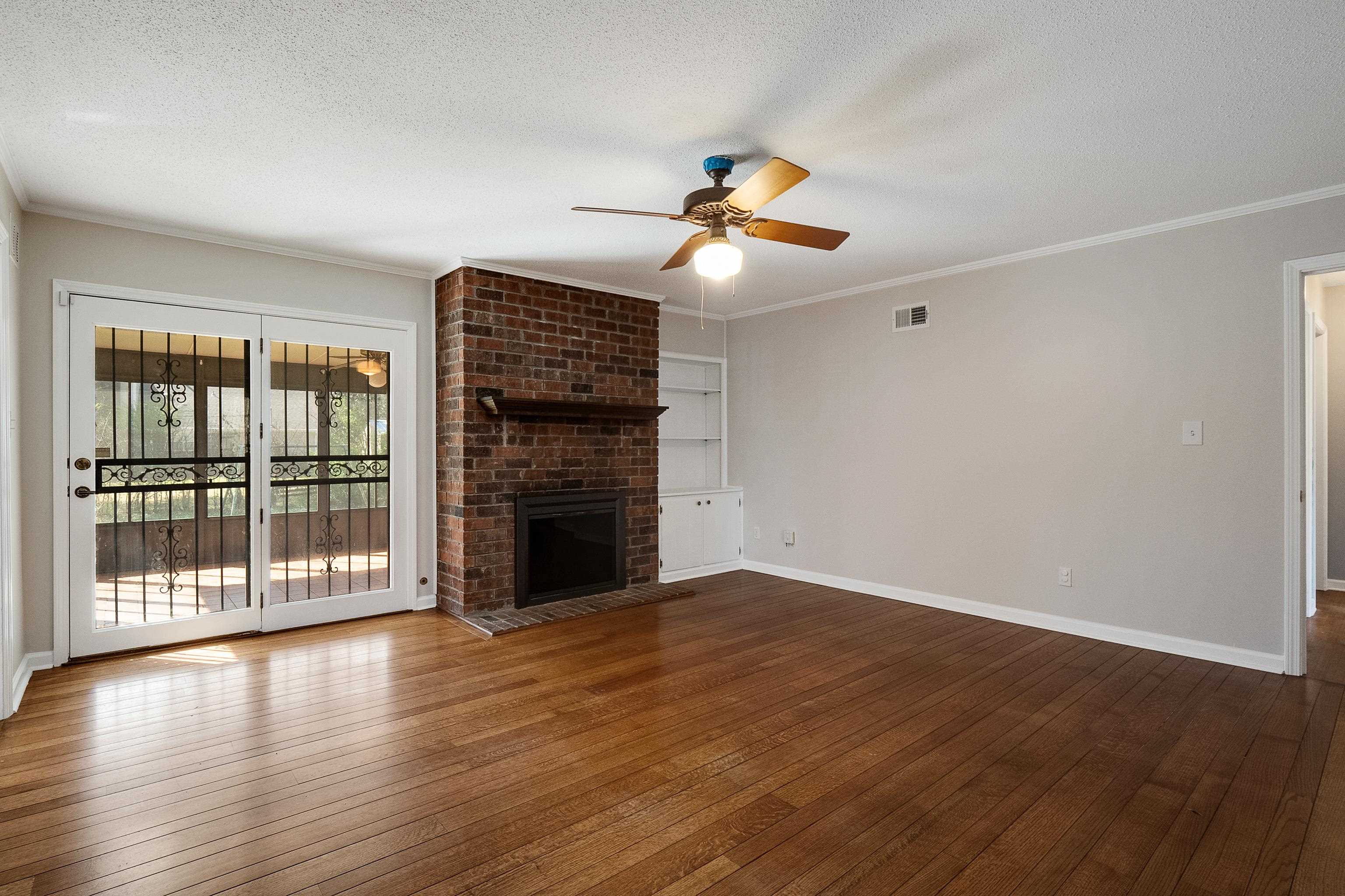 5849 Ridgevale Road Memphis, TN 38119 - Photo 8 of 22 wooden floor in an empty room with a window