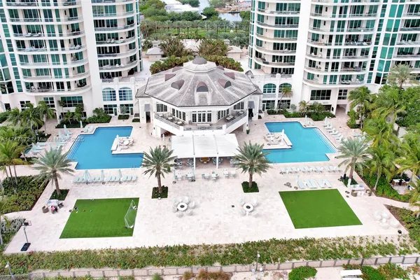 a view of a building with garden and sitting area