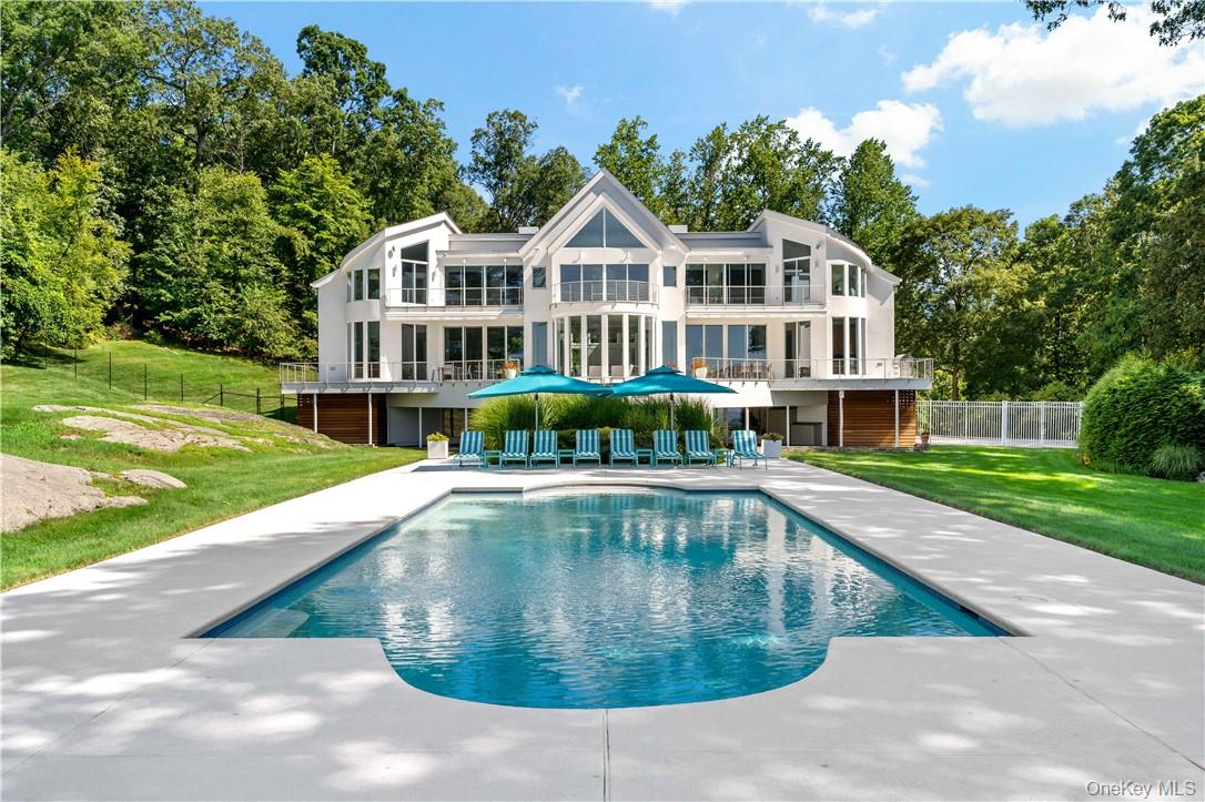 a view of a house with a yard and sitting area