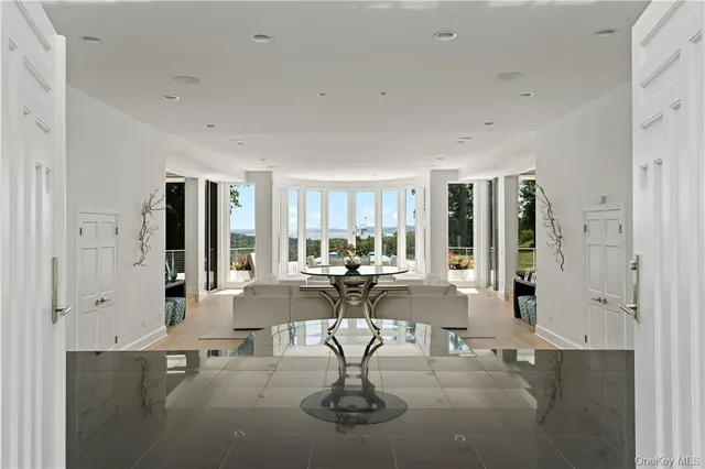 a view of living room filled with furniture and chandelier
