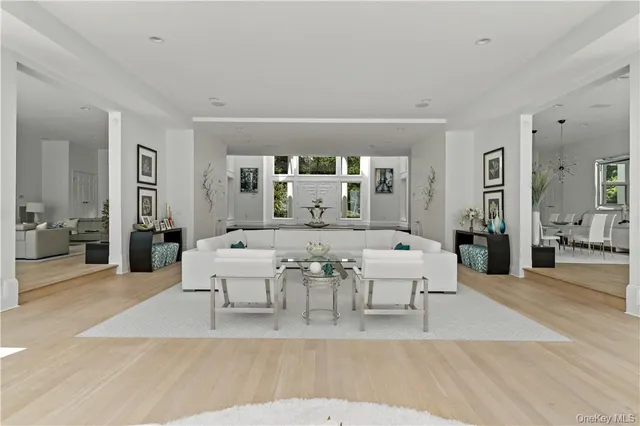 a living room with furniture a large window and a table