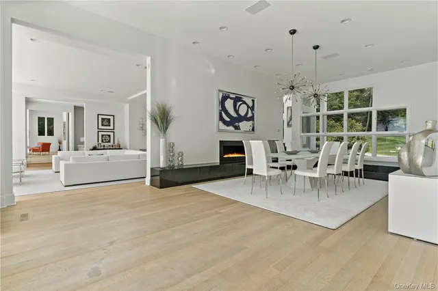 a view of a livingroom with furniture a fireplace and chandelier