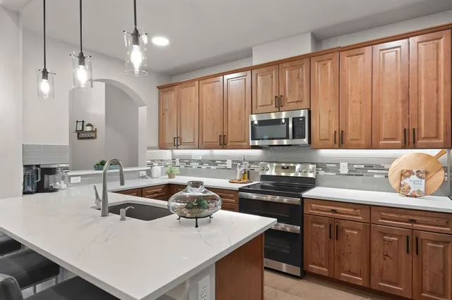 a kitchen with sink a stove and microwave