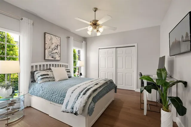a bedroom with a large bed and a chandelier