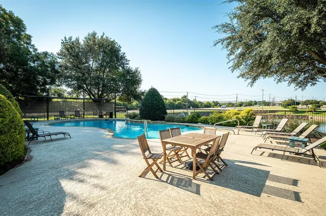 a front view of a house with a yard and potted plants