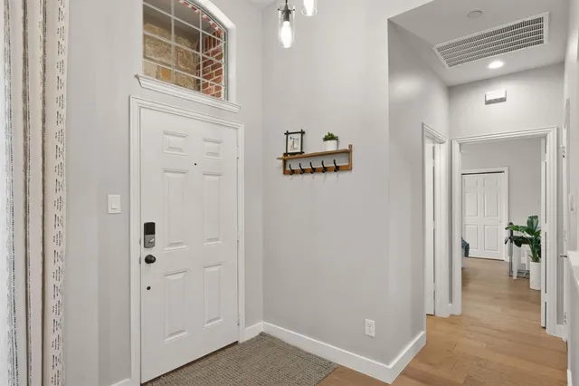 a view of a hallway with wooden floor