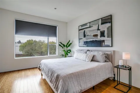 a bedroom with a large bed and a window