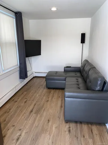 a living room with a couch and a flat screen tv