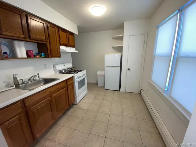 a kitchen with a sink a stove and refrigerator