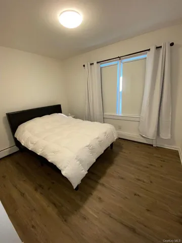a large bed sitting in a room next to a window