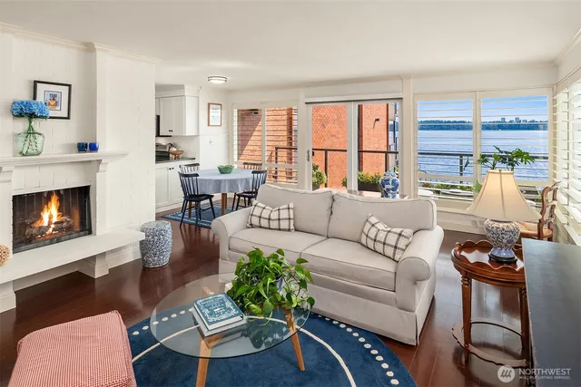 a living room with furniture large window and a fireplace